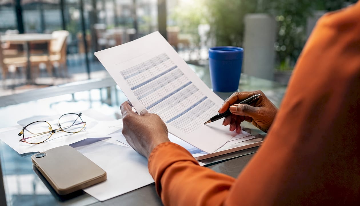 Hands typing employer cost calculations on keyboard