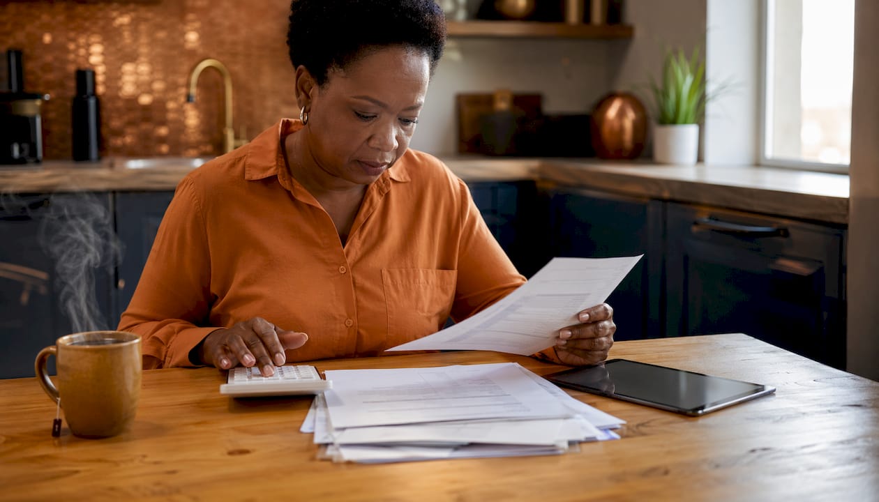 Finance worker calculating South Africa payroll compliance