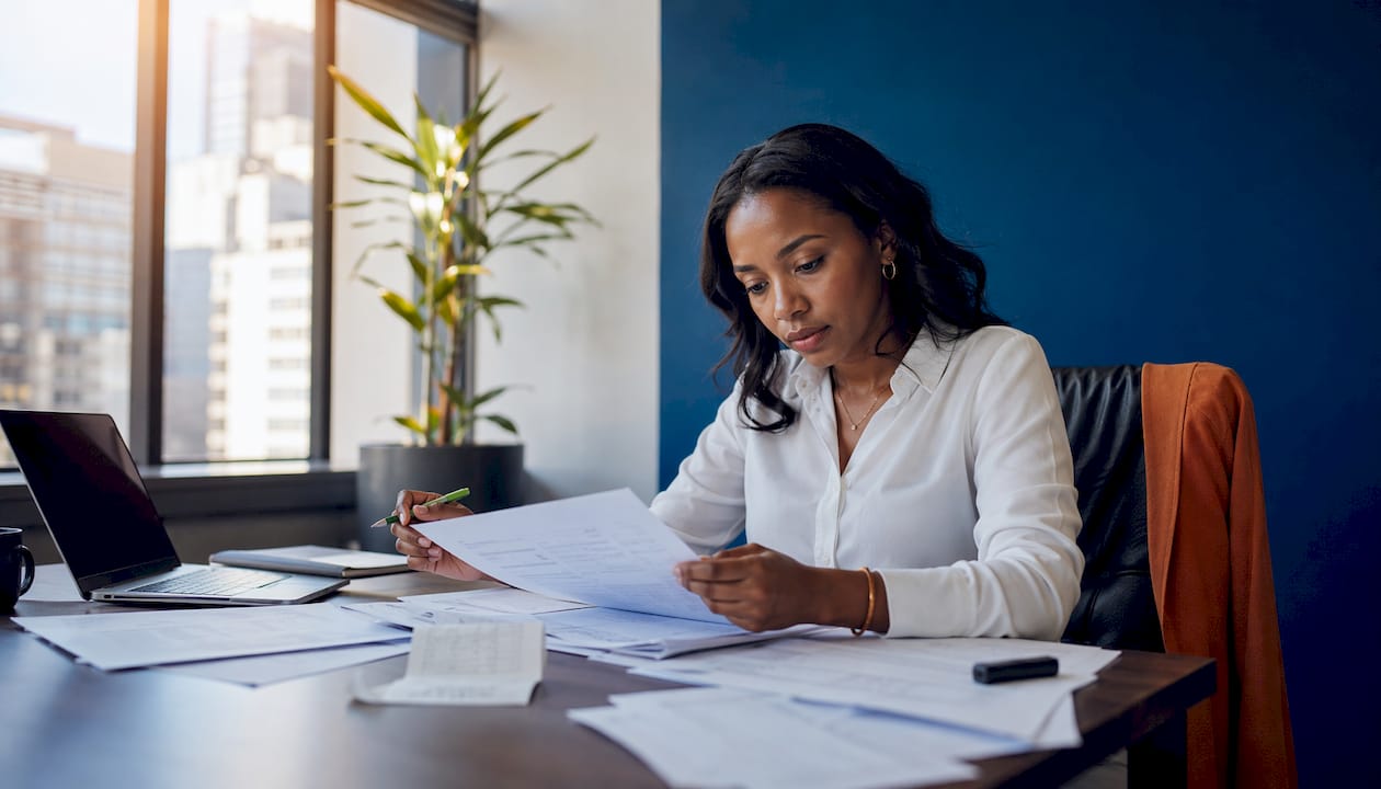 Accountant reviewing salary documents at office desk