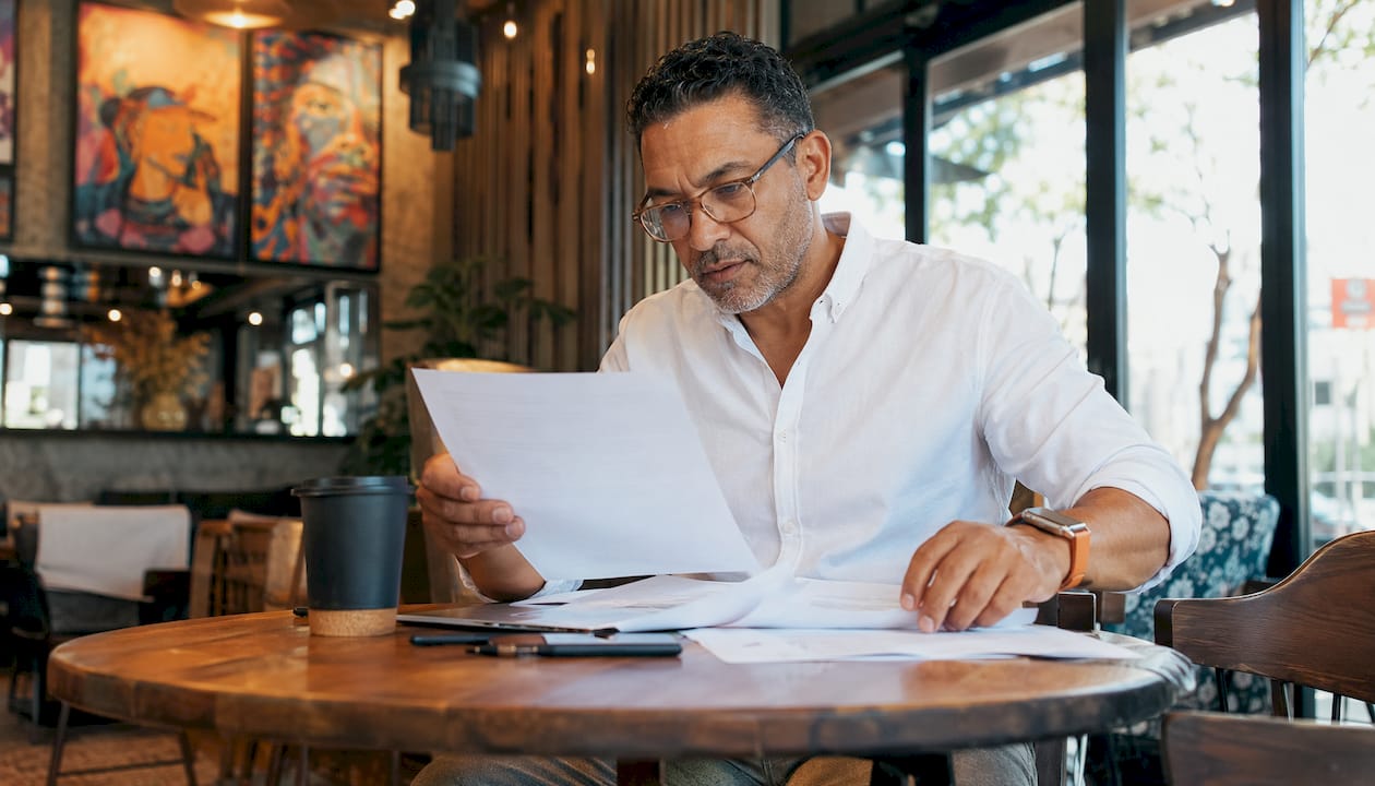 Male accountant sorting papers in manufacturing office