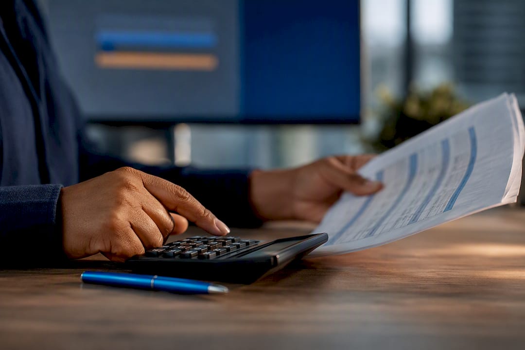 Hands calculating South African payroll deductions